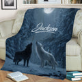 Moonlit winter wolf blanket spread across a sofa with two howling wolves