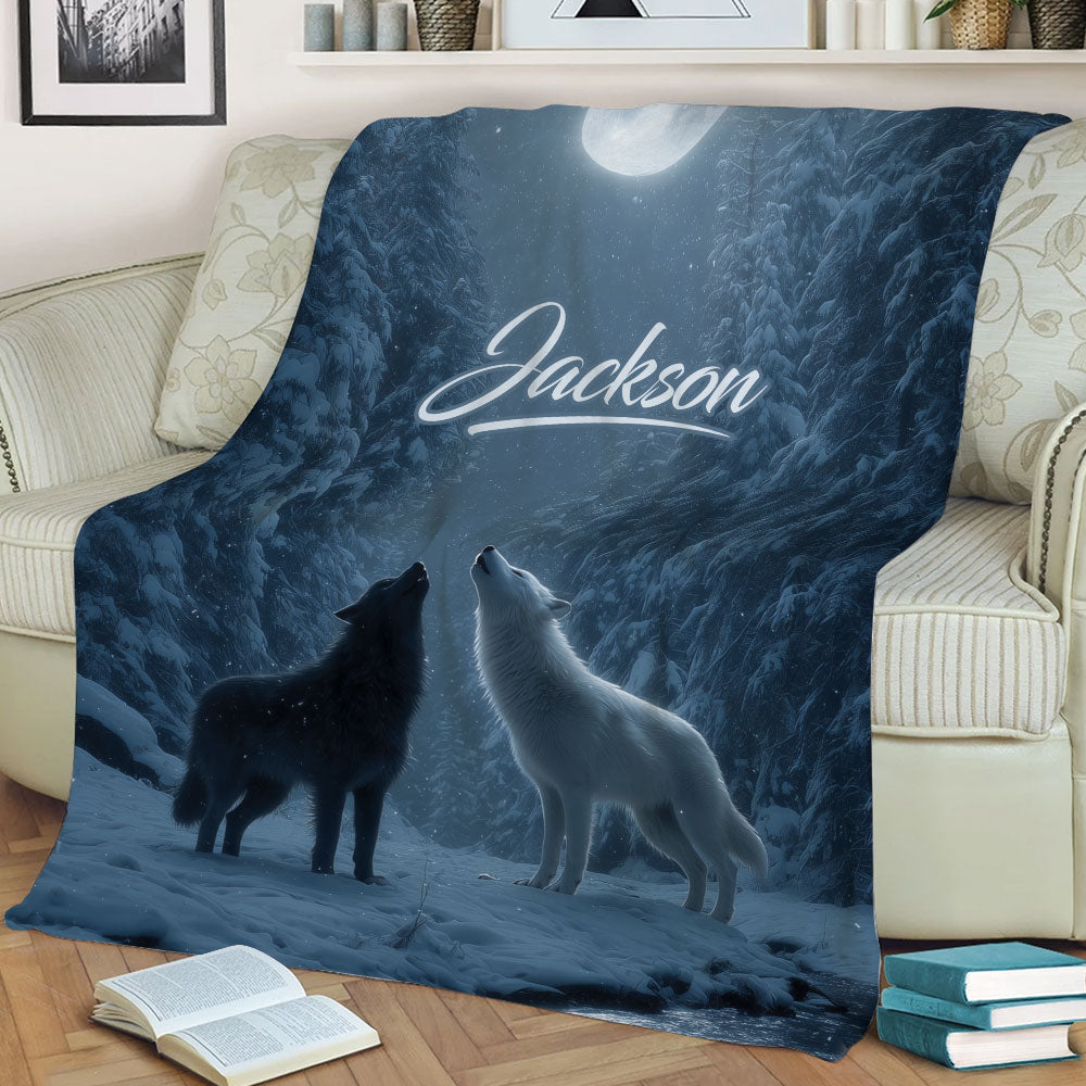 Moonlit winter wolf blanket spread across a sofa with two howling wolves