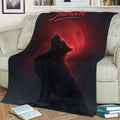Wildlife wolf blanket displayed on a sofa with a howling wolf beneath a glowing red moon
