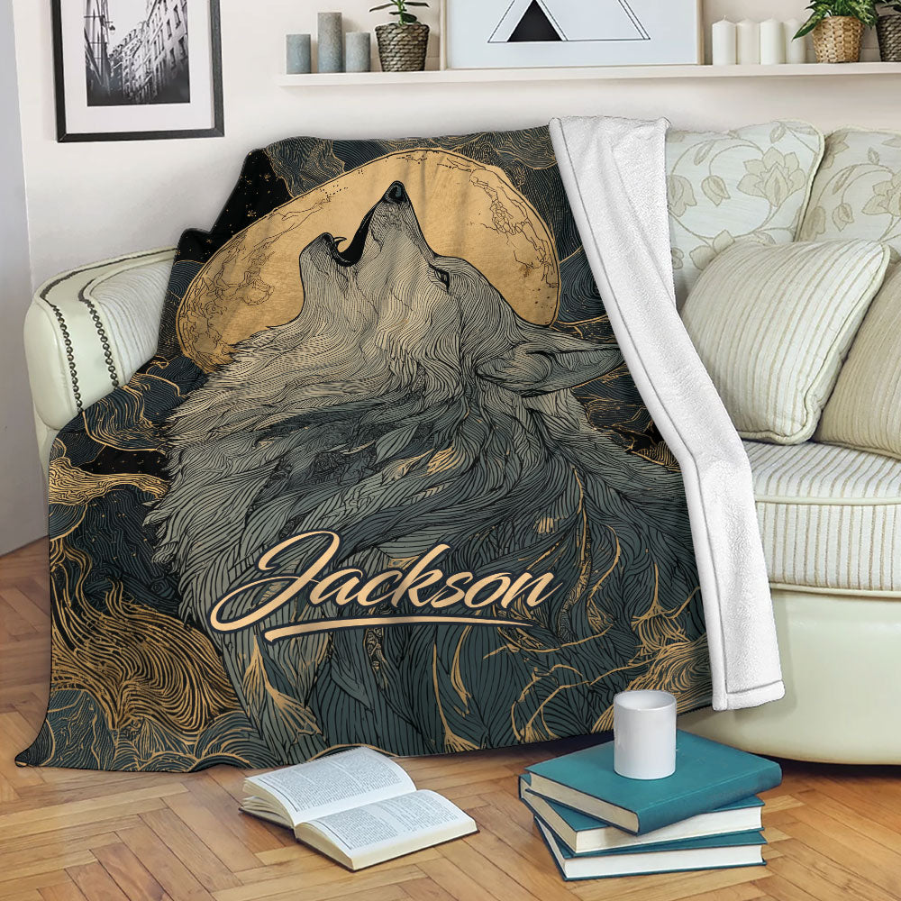 Howling wolf blanket displayed on a sofa with moon artwork and black and gold wildlife details