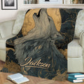 Close view of a howling wolf throw blanket featuring a large moon and flowing gold line patterns