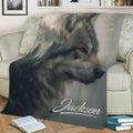 Close view of a wolf blanket displayed on a sofa with a realistic forest-inspired wildlife design