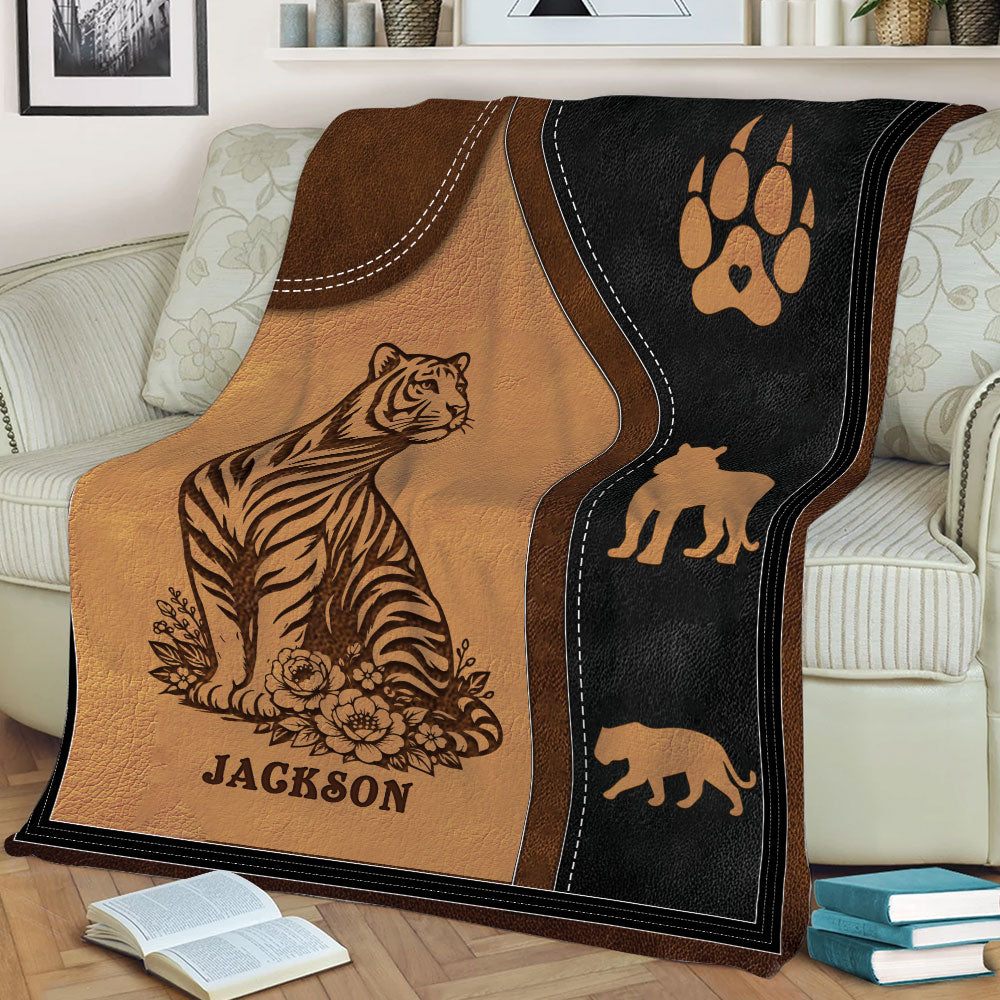 Close lifestyle view of a tiger throw blanket featuring floral details and animal silhouettes