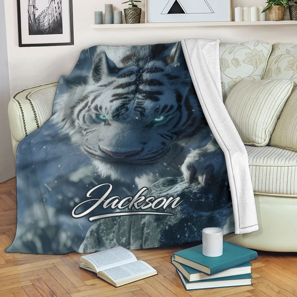 Blue tiger throw blanket displayed across a sofa with snowy wildlife artwork in a cozy living room