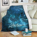 Blue tiger blanket draped over a sofa, featuring glowing wildlife artwork in a forest scene