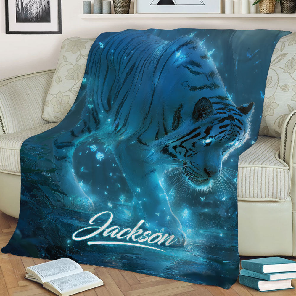 Blue tiger throw blanket styled on a sofa with dramatic glowing forest artwork