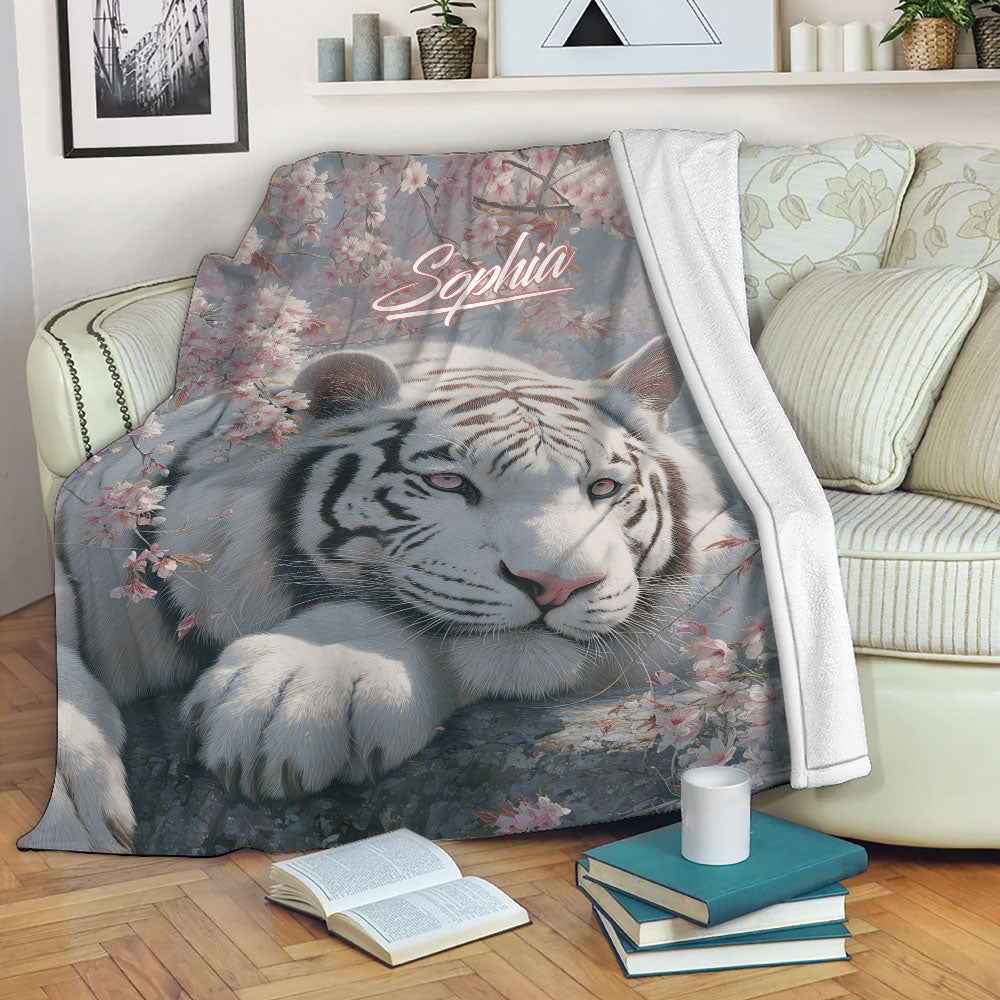White tiger blanket draped over a sofa with blooming branches and cozy living room decor