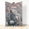 White tiger throw blanket with pink blossoms and a soft blue-gray floral background