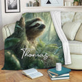 Sloth throw blanket draped over a sofa, featuring rainforest artwork with a peaceful sloth and tropical foliage