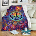 Colorful hippie throw blanket draped over a sofa with a floral peace sign and psychedelic mandala design