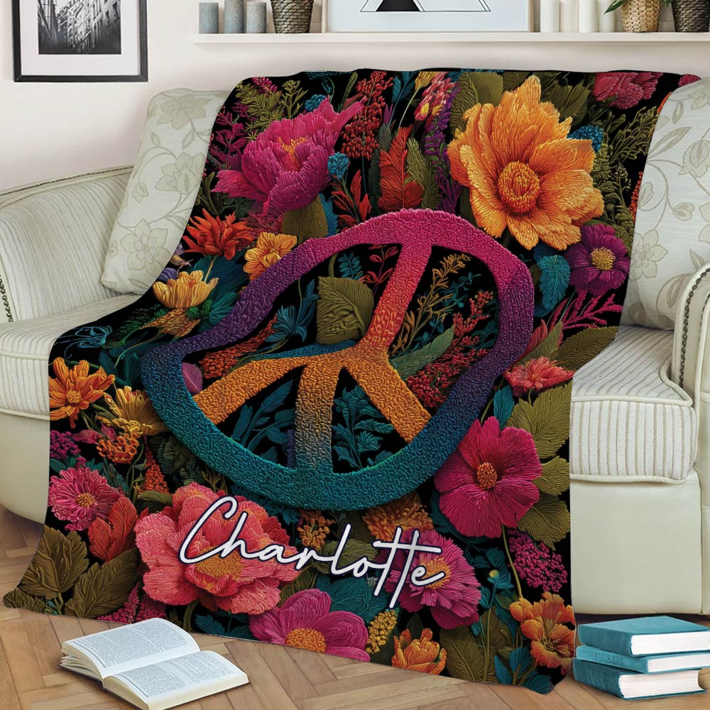 Close view of a colorful floral hippie blanket with a bold peace symbol on a couch