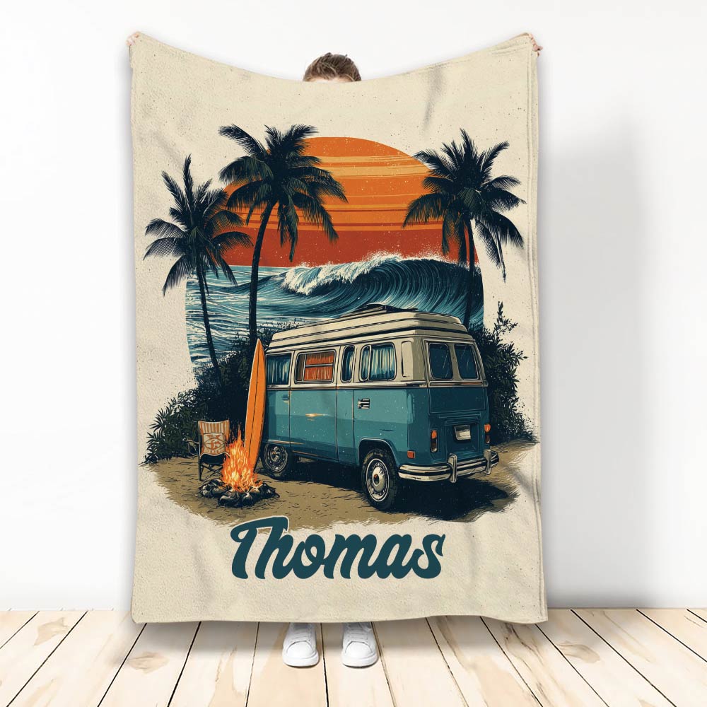 Camping throw blanket featuring a vintage camper van, campfire, palm trees, ocean waves, and sunset