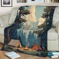 Mountain camping blanket draped over a sofa with pine forest, tents, and campfire design