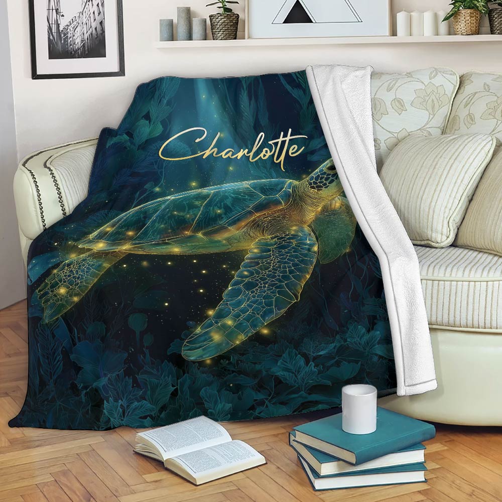 Sea turtle throw blanket displayed on a sofa with deep teal botanical and starry artwork