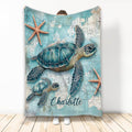 Custom turtle blanket displayed upright with sea turtle and starfish coastal artwork