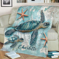 Close view of turtle throw blanket with ocean map artwork and starfish accents