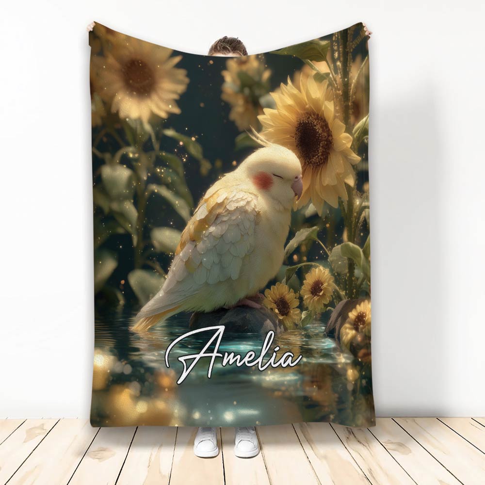 Cockatiel blanket featuring a resting bird among sunflowers, water, and warm golden botanical scenery
