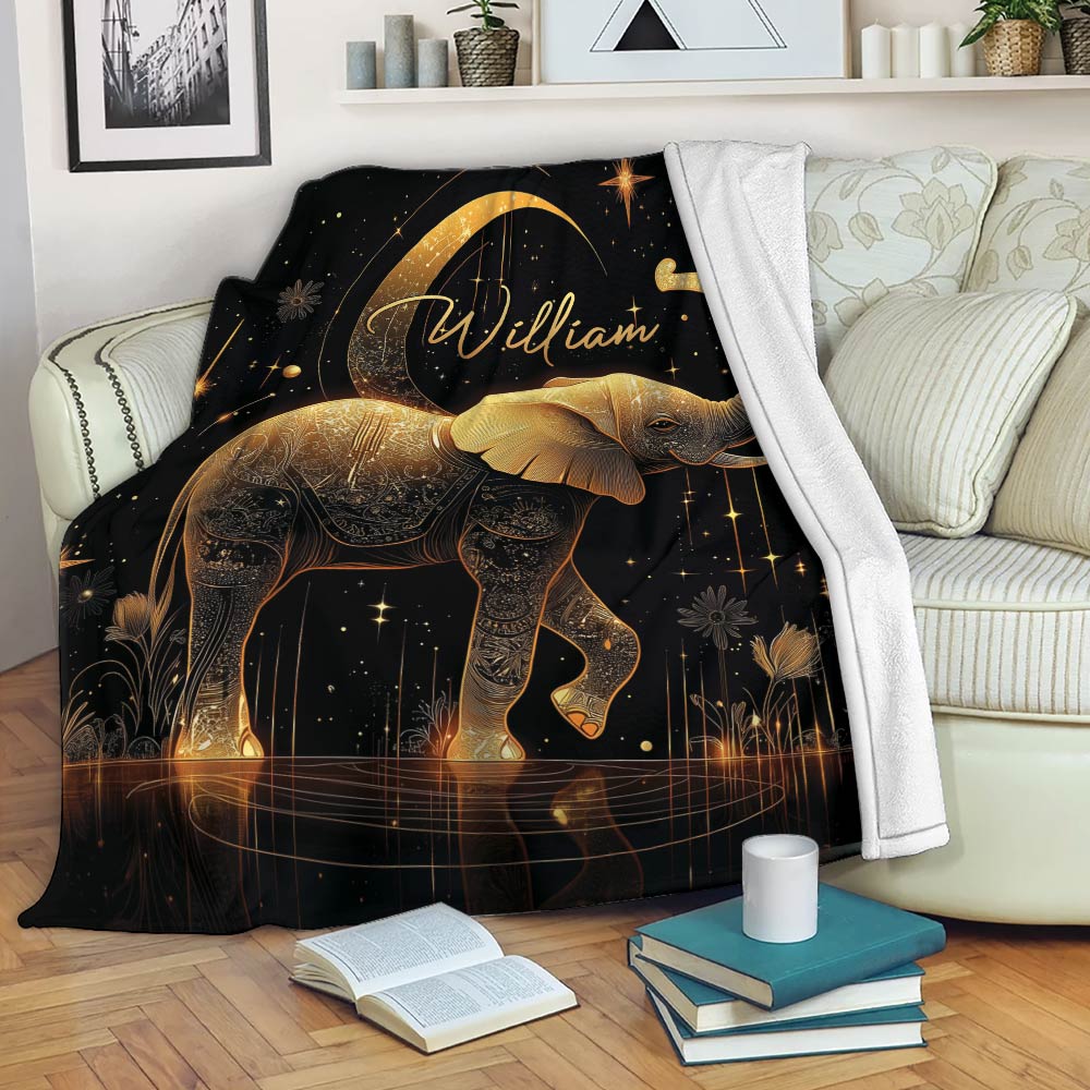 Elephant throw blanket with ornate gold artwork displayed on a living room couch