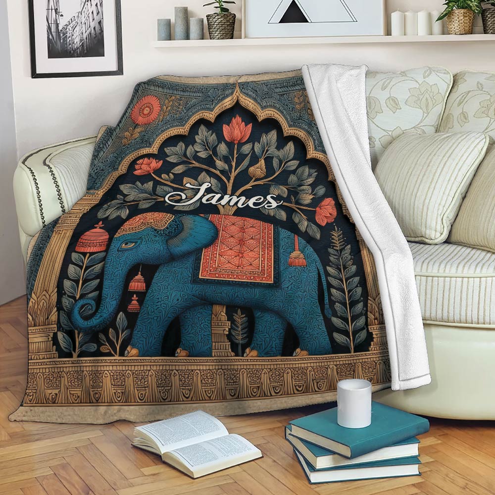 Elephant throw blanket displayed on a sofa with botanical and ornamental artwork