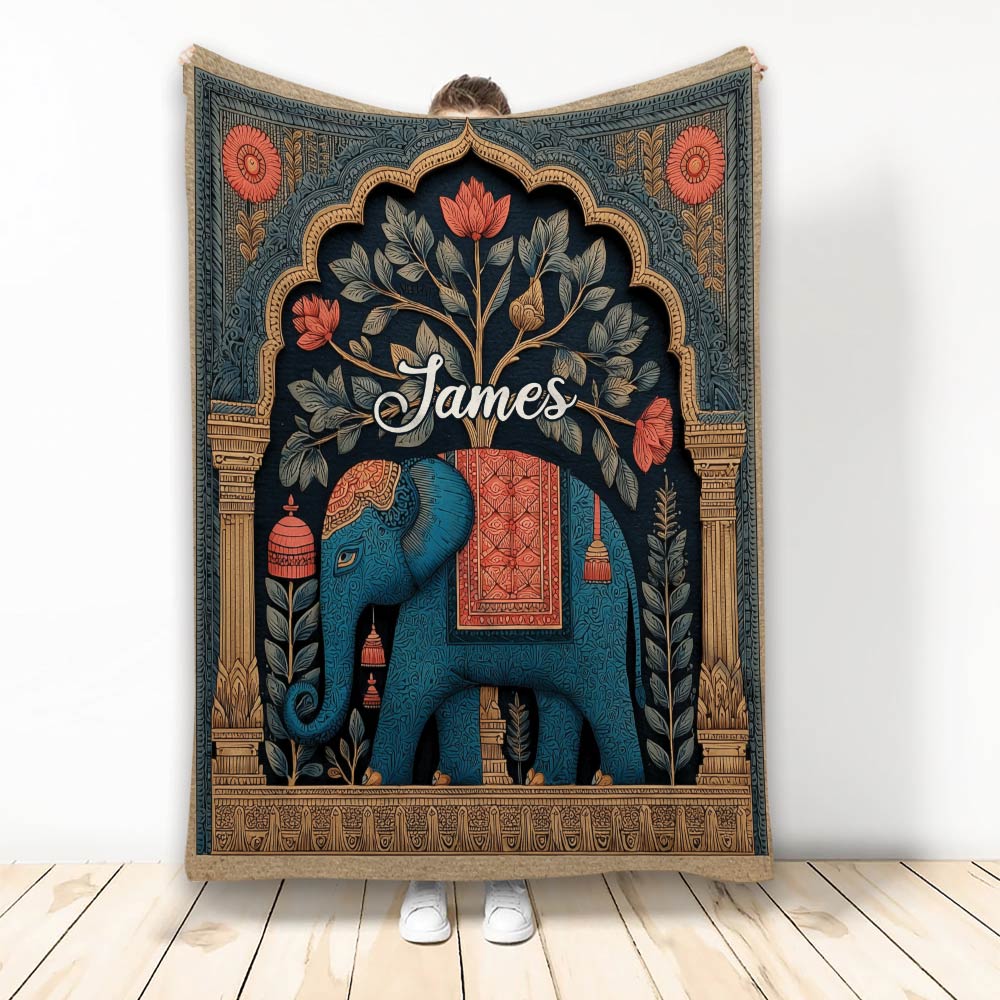 Ornate blue elephant blanket with botanical details and warm decorative border