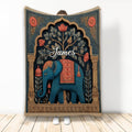 Ornate blue elephant blanket with botanical details and warm decorative border