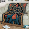 Decorative elephant blanket draped over a sofa in a cozy living room setting