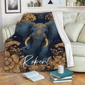 Elephant blanket draped across a sofa with navy and gold floral artwork in a cozy living room
