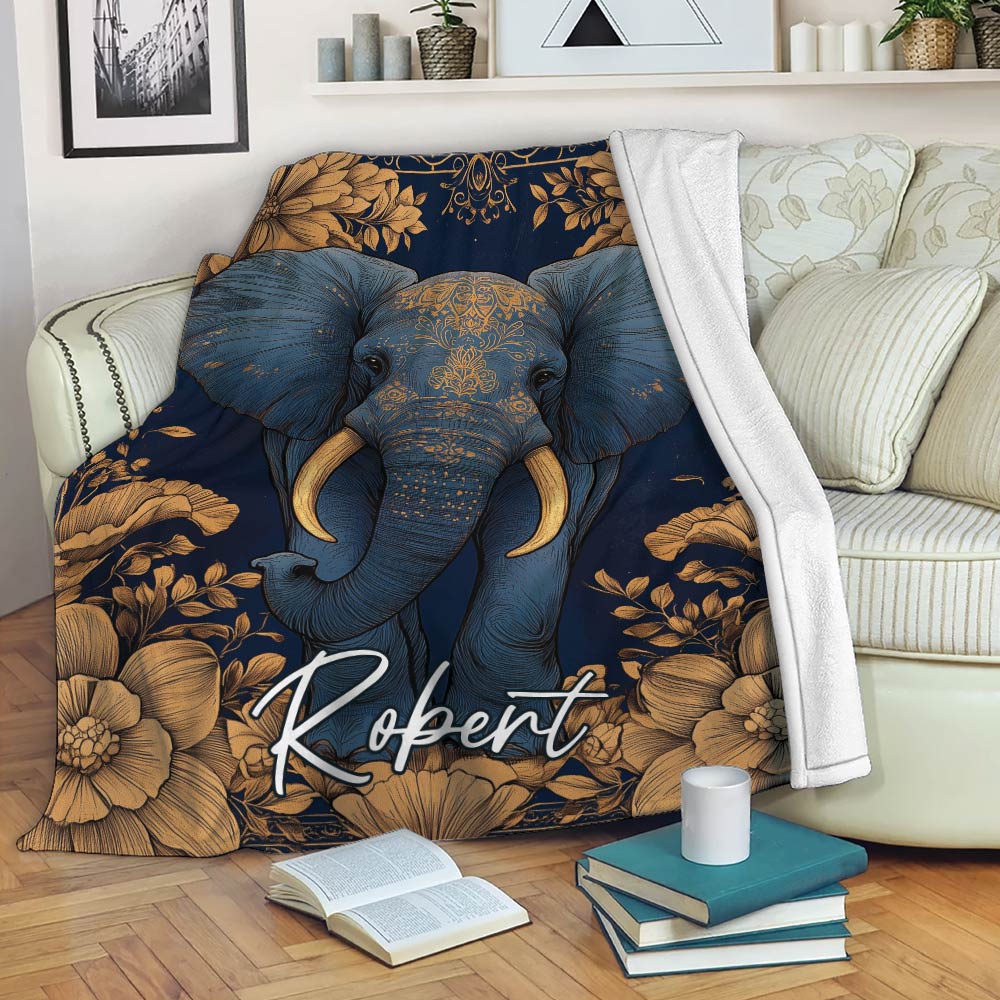 Elephant blanket draped across a sofa with navy and gold floral artwork in a cozy living room