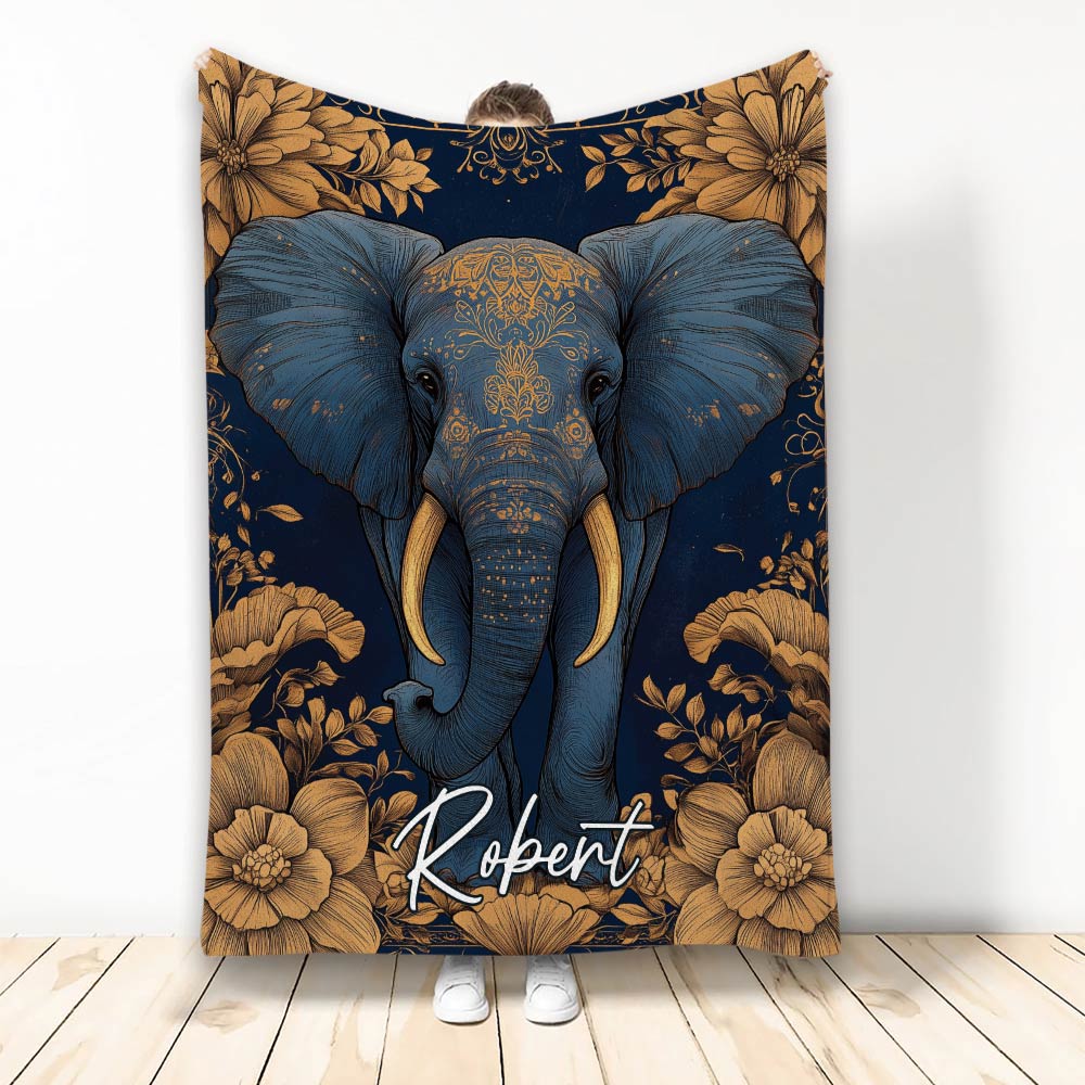 Elephant throw blanket with ornate navy and gold artwork, floral border, and a cozy lifestyle display