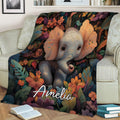 Colorful elephant and tropical flower blanket styled across a living room sofa