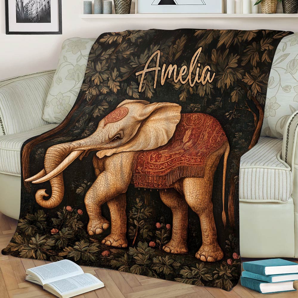 Close view of an elephant throw blanket with ornate saddle artwork and dark floral foliage