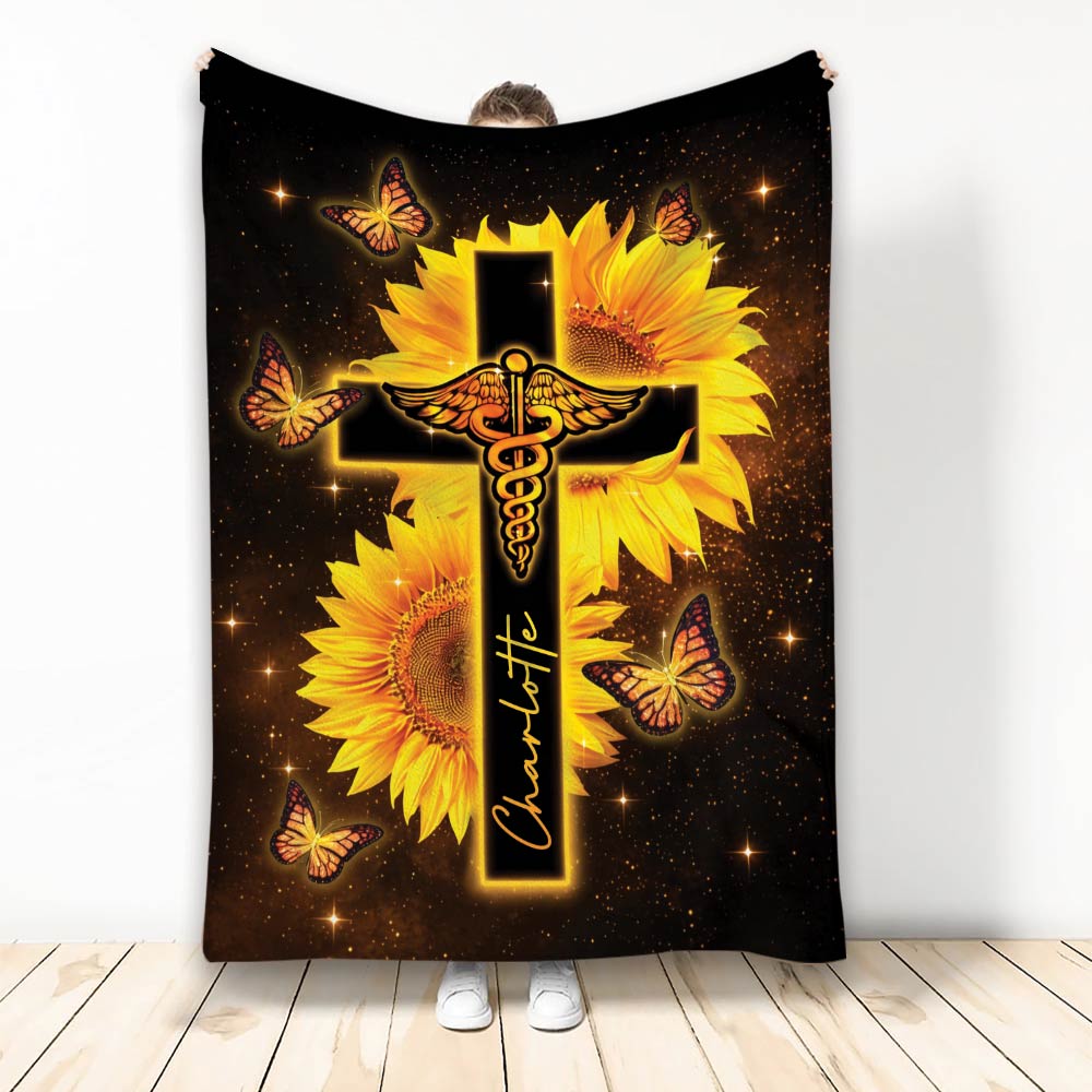 Nurse blanket featuring a glowing medical caduceus and cross surrounded by sunflowers and butterflies
