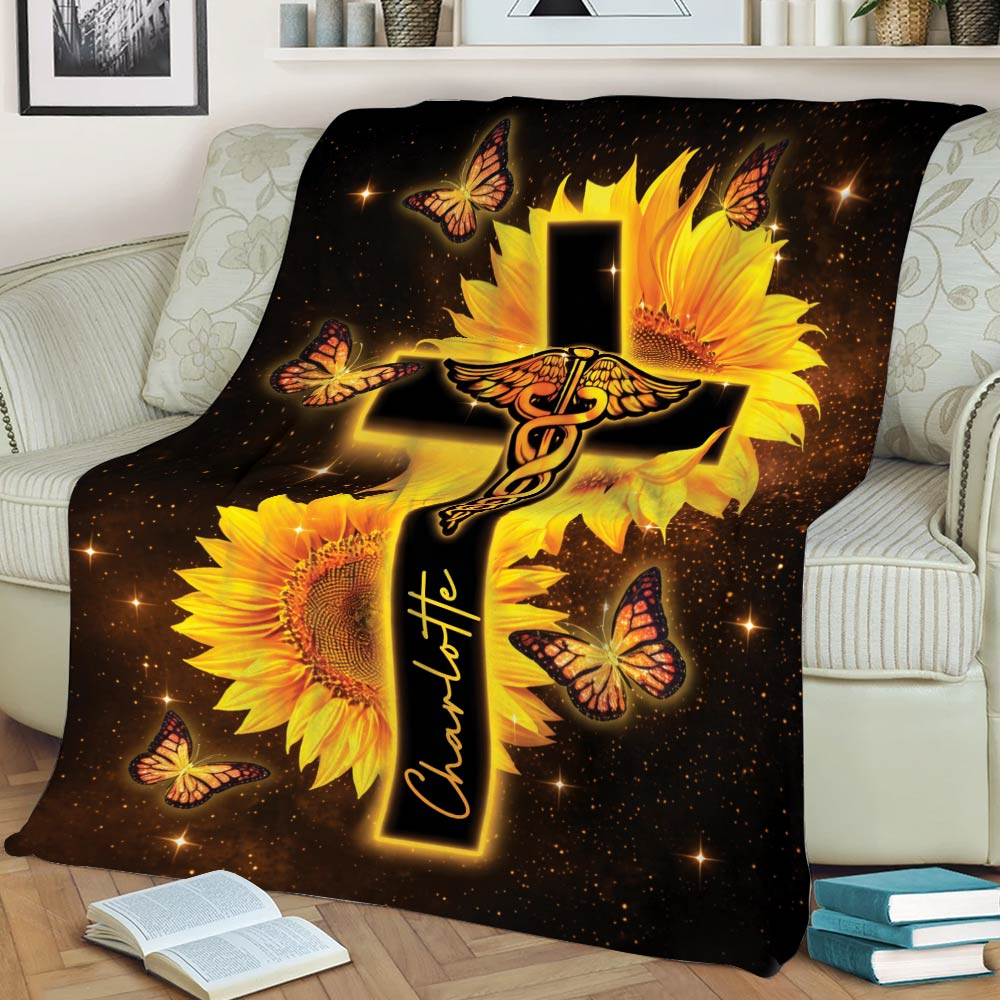 Nurse blanket draped over a chair showing a medical caduceus, glowing cross, sunflowers, and butterflies