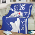 Nurse throw blanket spread across a sofa with blue and white medical-themed design