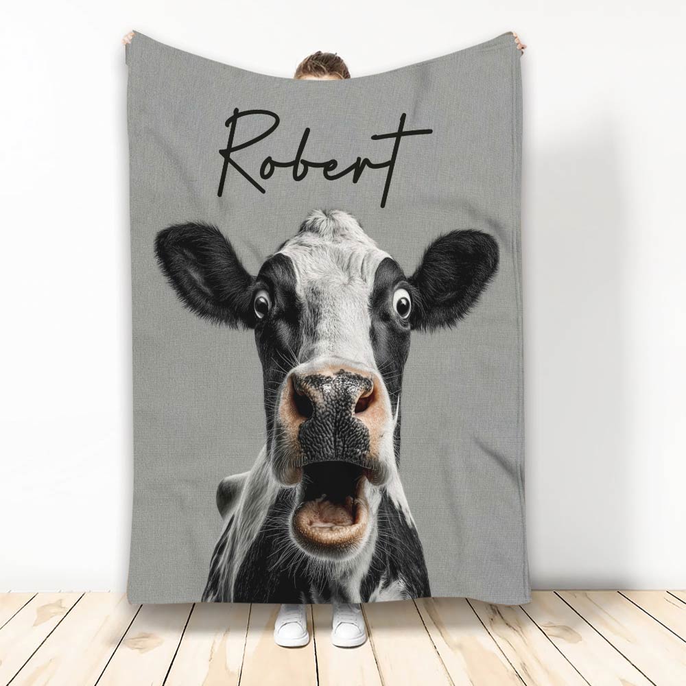 Custom cow throw blanket featuring a humorous black and white cow close-up on gray artwork