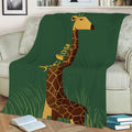 Close view of a green giraffe throw blanket styled on a sofa with illustrated grassland artwork