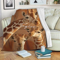 Giraffe throw blanket displayed on a living room sofa with warm wildlife artwork