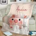 Pink pig throw blanket styled on a sofa with a soft blush background and cozy artwork
