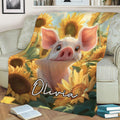 Cheerful pig and sunflower throw blanket styled across a sofa in a bright living room