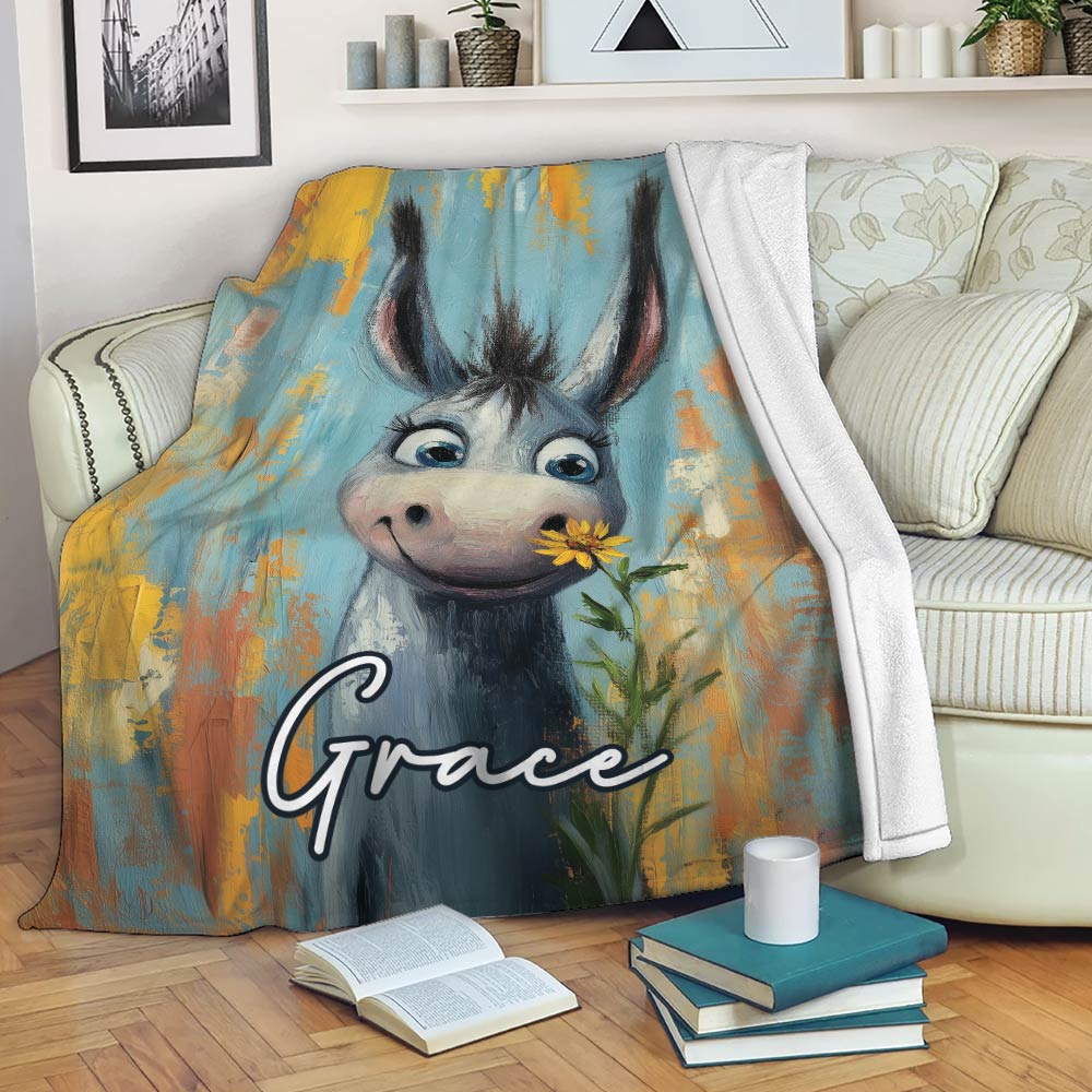 Whimsical donkey throw blanket draped over a sofa with colorful blue, yellow, and orange artwork