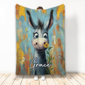 Donkey throw blanket featuring a whimsical gray donkey holding a yellow flower against colorful painted artwork