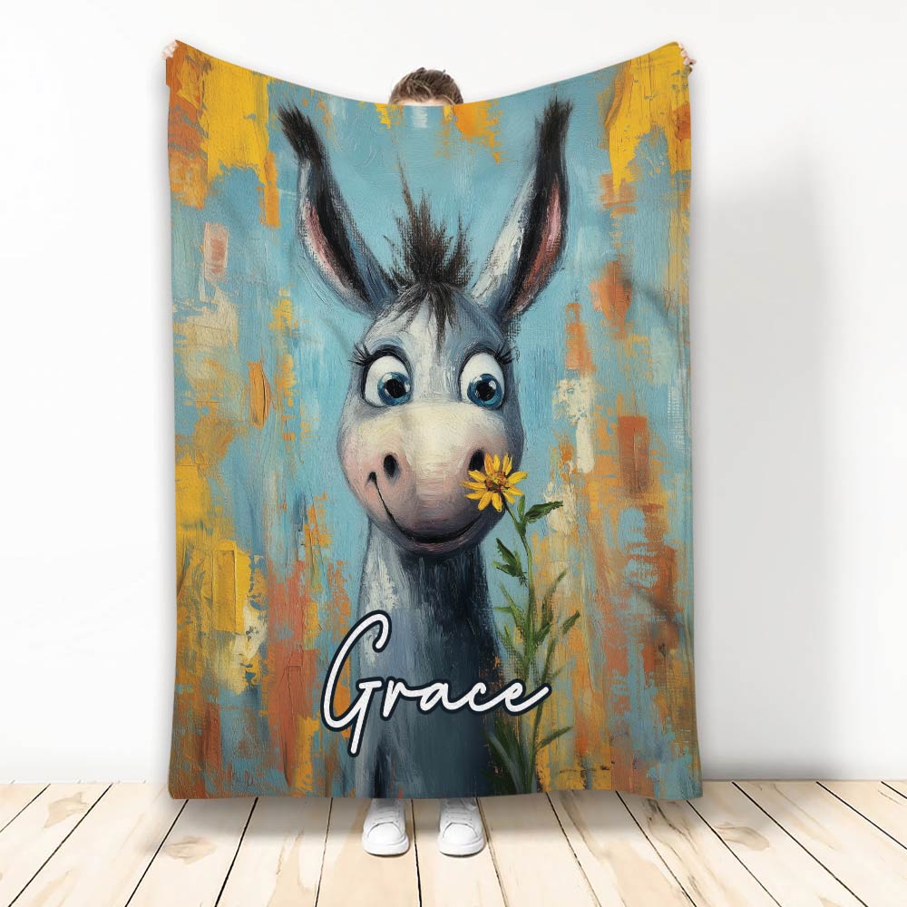 Donkey throw blanket featuring a whimsical gray donkey holding a yellow flower against colorful painted artwork