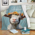 Floral goat throw blanket draped over a sofa with books and a mug in a cozy living room