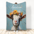 Floral goat artwork on a blue custom throw blanket displayed upright in a bright room