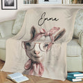 Close view of a whimsical goat throw blanket with glasses, pink bows, and elegant vintage artwork on a sofa
