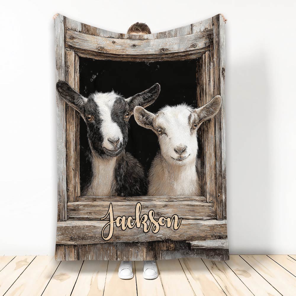 Goat throw blanket featuring two goats in a rustic wooden barn window design