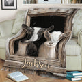 Two-goat blanket displayed across a sofa with rustic barn window artwork