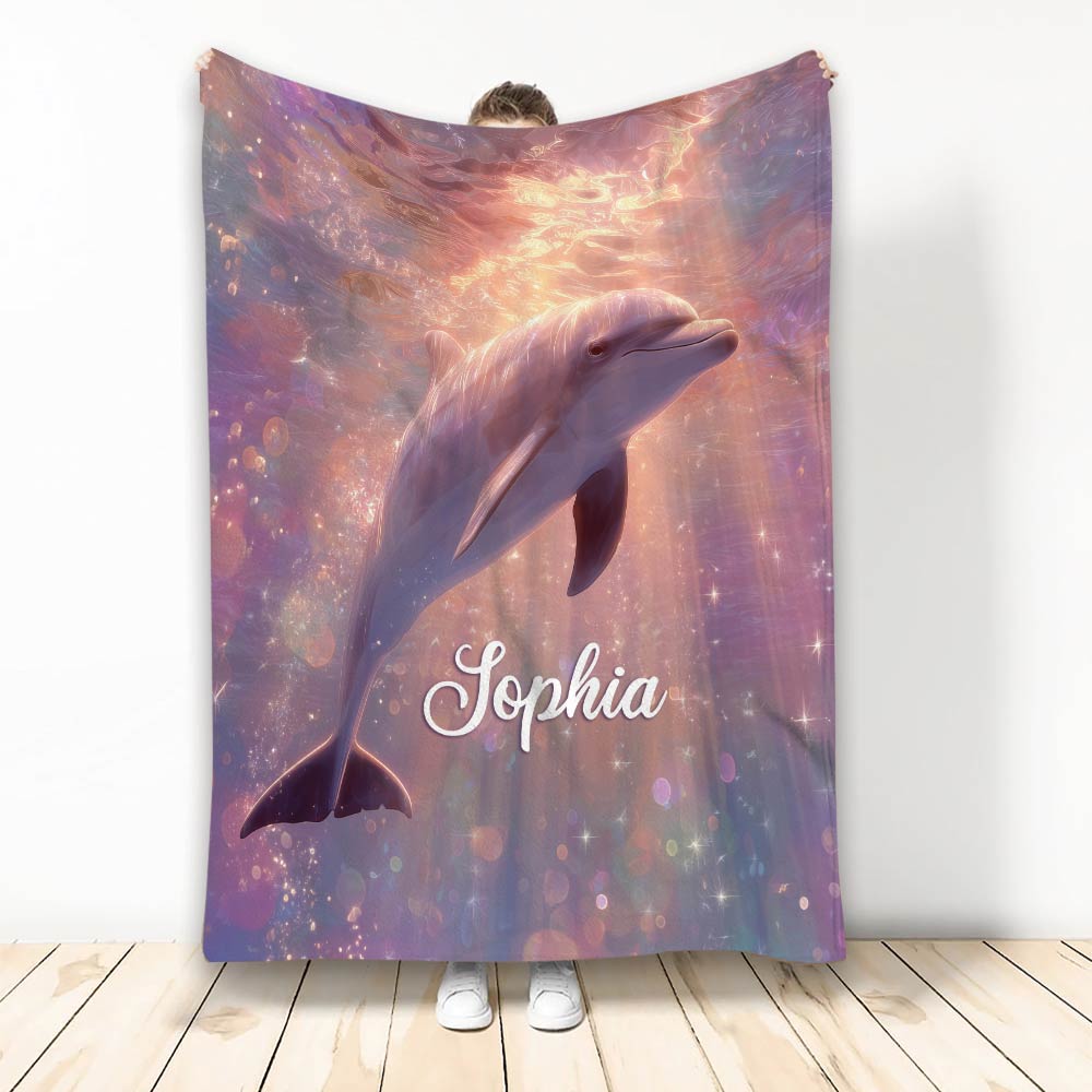 Pastel dolphin blanket with glowing ocean-inspired artwork and dreamy purple, pink, and blue colors