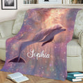 Dolphin blanket displayed on a couch with luminous underwater artwork and a colorful dreamy theme