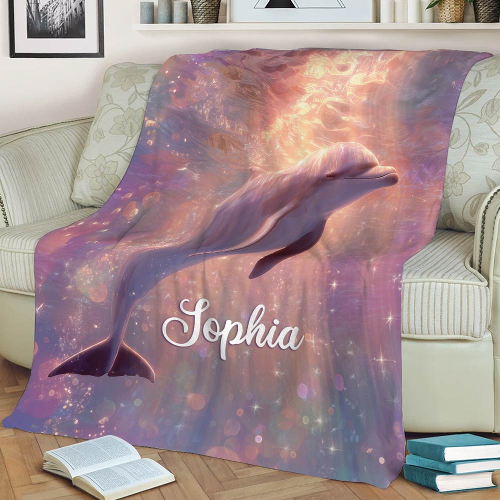 Dolphin blanket displayed on a couch with luminous underwater artwork and a colorful dreamy theme